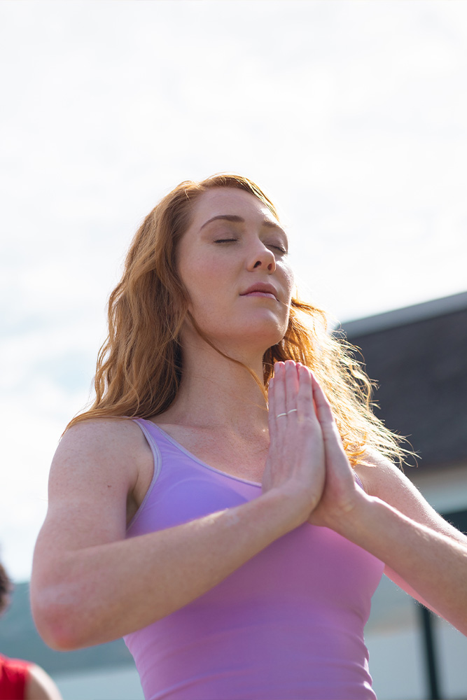 Woman performing yoga during a holistic therapy session at SD Wellness