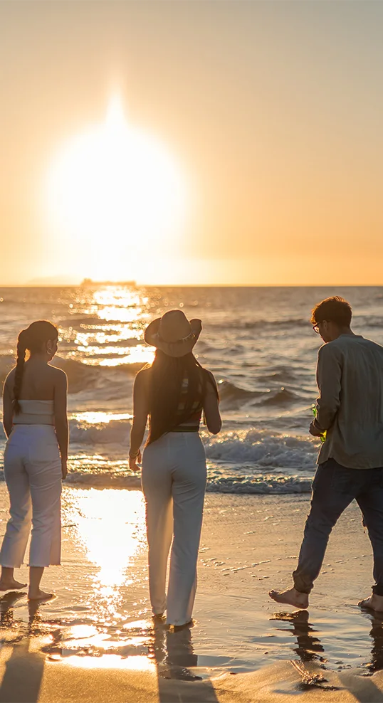 Group of friends walking along the beach at sunset, symbolizing healing, connection, and recovery at San Diego Wellness Center.