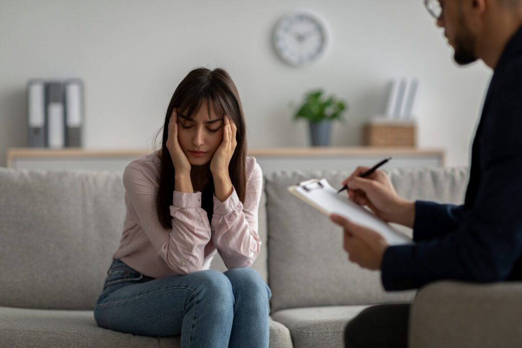 Woman speaks with a therapist during trauma-focused PTSD therapy in San Diego for mental health and recovery support.