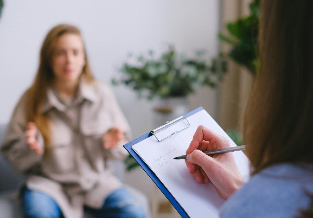 Therapist takes notes during a counseling session for cocaine addiction treatment and recovery support.