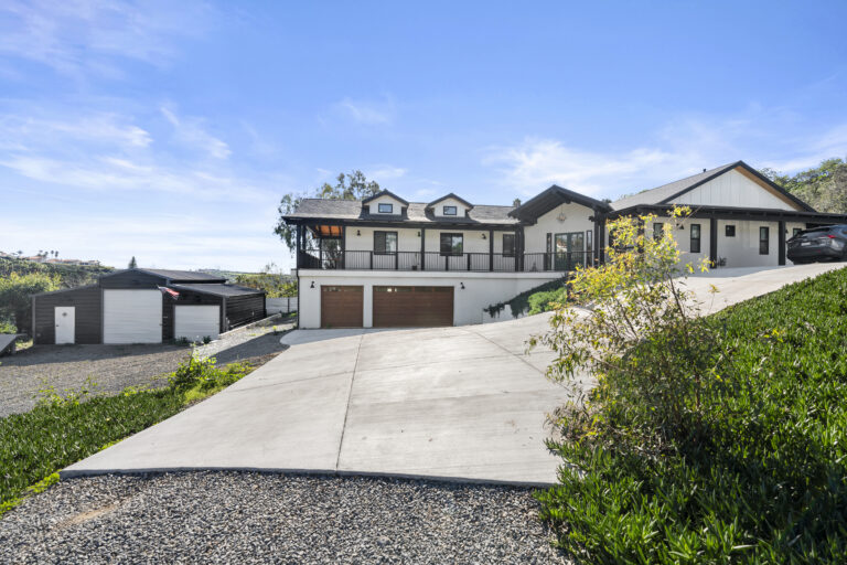 Beautifully spacious home of the SD-Wellness Drug Rehab Facility in Ironwood, CA. Clear blue sky with a bright white painted home that has a brown rooftop.
