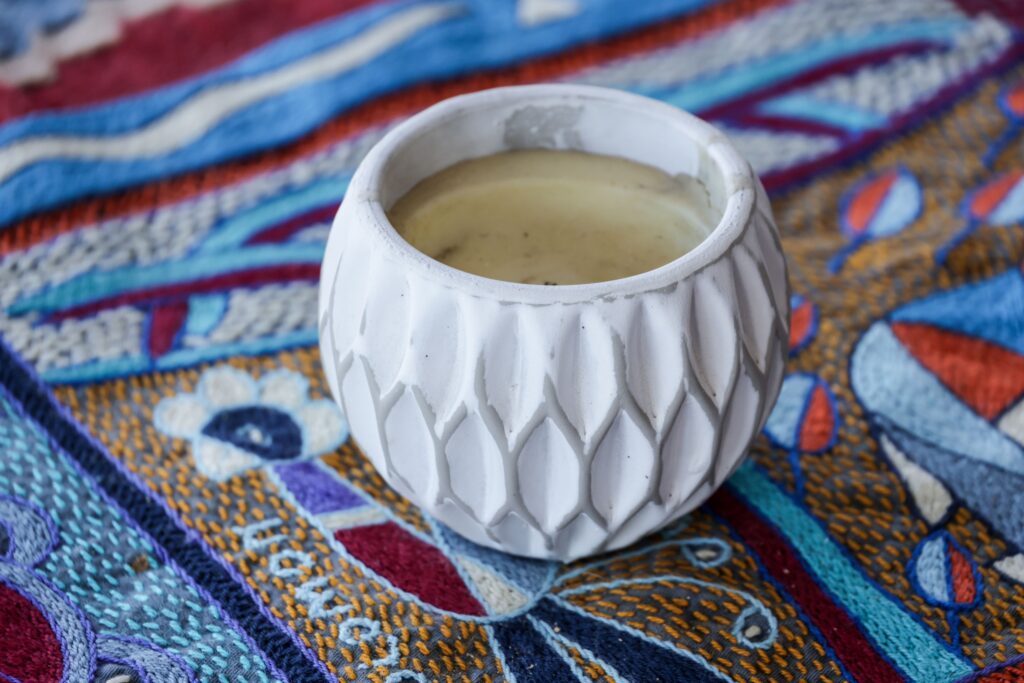 kava in a white patterned cup with a colorful background. Addiction recovery at San Diego Wellness Center.
