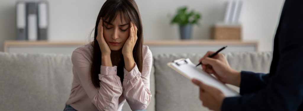 Woman speaks with a therapist during trauma-focused PTSD therapy in San Diego for mental health and recovery support.